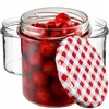 Three glass jars, one filled with red cherries and a red and white checkered lid, are arranged on a white background. Produktbild-Vorschau