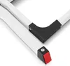 A close-up view of the white metal frame of a folding step stool, showing the black plastic corner protectors and a red textured foot pad on one of the legs. Produktbild-Vorschau