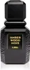 A black perfume bottle with a gold label. Voir les images du produit
