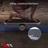 A person is using a balance board on a mat outdoors. Produktbild-Vorschau