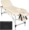 A cream-colored massage table with silver legs and a black carrying case is shown against a white background. Voir les images du produit