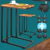 A collage of images showing a C-shaped side table with a wooden top and black metal frame, along with its components like wheels and adjustable feet. Anteprima dell’immagine prodotto