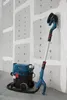 A Bosch vacuum cleaner and a long-reach sander are set up in a room with unfinished drywall. Podgląd zdjęcia produktu