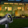 A laser light projector is shown in a garden at night, projecting red and green lights onto a modern house. Produktbild-Vorschau