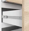 Close-up view of an open drawer in a white and wood-effect cabinet, showing the drawer slide mechanism. Podgląd zdjęcia produktu
