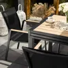 Outdoor patio setting with a table and chairs. Produktbild-Vorschau