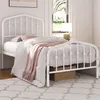A white metal bed frame with bedding in a bedroom setting. Produktbild-Vorschau