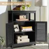 A black wooden cabinet with two louvered doors, displaying decorative items and storage boxes. Voir les images du produit