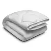 A folded white duvet is presented against a white background. Produktbild-Vorschau