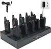 A multi-unit charger with multiple walkie-talkies plugged in, connected to a power source. Voir les images du produit