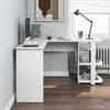 A white L-shaped desk with shelves is shown in a room setting. Produktbild-Vorschau