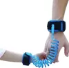 Two hands, one adult and one child, are connected by a blue coiled leash. Náhľad obrázku produktu