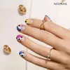 A close-up shot of a hand with colorful, patterned nail art and rings. Voir les images du produit