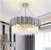 A modern chandelier hanging from a white ceiling. Produktbild-Vorschau