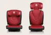 Two red car seats are shown side-by-side against a light gray background. The seat on the right has its headrest extended higher than the seat on the left, indicating adjustability. Produktbild-Vorschau