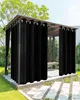 A black outdoor curtain hanging from a gazebo in a garden setting. Náhľad obrázku produktu
