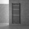 A dark anthracite radiator is mounted on a gray tiled wall in a modern bathroom. Produktbild-Vorschau