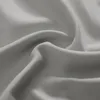 A close-up view of gray fabric with soft folds and shadows. Produktbild-Vorschau