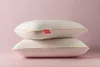 Two white pillows are stacked on a pink background. Produktbild-Vorschau