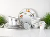 A collection of porcelain dinnerware with fruit motifs, including plates, bowls, and mugs, arranged on a white surface. Náhľad obrázku produktu