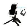 A smartphone is mounted on a black tripod stand. A separate phone holder is shown to the right, with an arrow pointing to it from text indicating it is included in the set. Produktbild-Vorschau