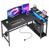 A gaming L-shaped desk with dual monitors, keyboard, mouse, computer tower, and accessories. Anteprima dell’immagine prodotto