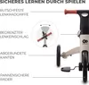 Close-up view of a children's tricycle, highlighting safety features with text labels and diagrams. Produktbild-Vorschau