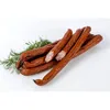 A pile of smoked sausages with dill on a white background. Produktbild-Vorschau