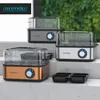 Three Arendo egg cookers are displayed on tiered surfaces, with a black four-egg holder in the foreground. Náhľad obrázku produktu