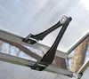 A close-up view of a black hinge mechanism attached to the clear, ribbed roof of a greenhouse. Produktbild-Vorschau