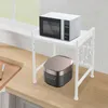 A kitchen counter with a microwave shelf holding a microwave and a rice cooker, with utensils hanging from the shelf. Náhled obrázku produktu