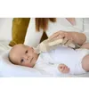 A person is holding a toy near a baby. Anteprima dell’immagine prodotto