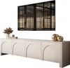A modern, minimalist TV board with decorative elements and artwork displayed above it. Produktbild-Vorschau