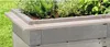 A close-up view of a raised garden bed with plants growing in it, showing the side and top edge of the bed. Anteprima dell’immagine prodotto