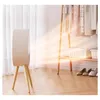 A white electric heater with wooden legs is shown in a room with clothes on a rack and shoes on the floor. Produktbild-Vorschau