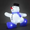 A lit-up acrylic snowman decoration with a black hat, blue scarf, and blue boots, set against a dark background. Produktbild-Vorschau