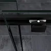 A close-up view of a black shower door handle and frame, with a tiled floor in the background. Produktbild-Vorschau