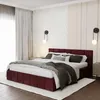 A bedroom scene featuring a burgundy upholstered bed. Produktbild-Vorschau