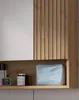 A close-up view of a bathroom cabinet with a mirror and shelf. Produktbild-Vorschau