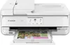 A white Canon PIXMA TS9551Ca printer is shown from the front, with a printed document in the output tray. Podgląd zdjęcia produktu