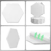 A collage of four images showing white hexagonal acoustic panels from different angles, including a stack of panels and a close-up of the adhesive backing. Produktbild-Vorschau