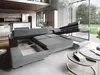 A modern living room with a large sectional sofa that has storage compartments and a pull-out bed feature. Produktbild-Vorschau