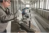 A man is using a Bosch drill press to drill into a metal beam in a construction environment. Anteprima dell’immagine prodotto