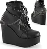 A pair of black platform wedge boots with gothic-style embellishments. Produktbild-Vorschau