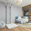 A child's bedroom with a gym setup and a bed. Produktbild-Vorschau
