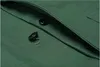 A close-up view of a green garment with black buttons. Produktbild-Vorschau