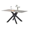 A rectangular dining table with a marble-effect top and a black, X-shaped base, set against a white background. A glass pitcher and a glass are placed on the table, along with a small vase of flowers. Produktbild-Vorschau