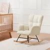 A beige teddy plush rocking chair is shown in a nursery setting next to a wooden crib. Podgląd zdjęcia produktu