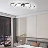 A modern bedroom with a large window showing a city view at night, and a contemporary ceiling light fixture. Voir les images du produit