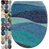 A collage showing a toilet seat with a mosaic wave design as the main product, surrounded by smaller images of various other toilet seat designs. Produktbild-Vorschau